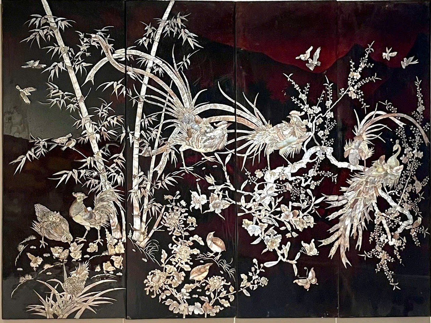 Tứ quý — Trees, flowers and pale decorative details unfold across four dark panels. The supplied condition note records some age-related scratches.