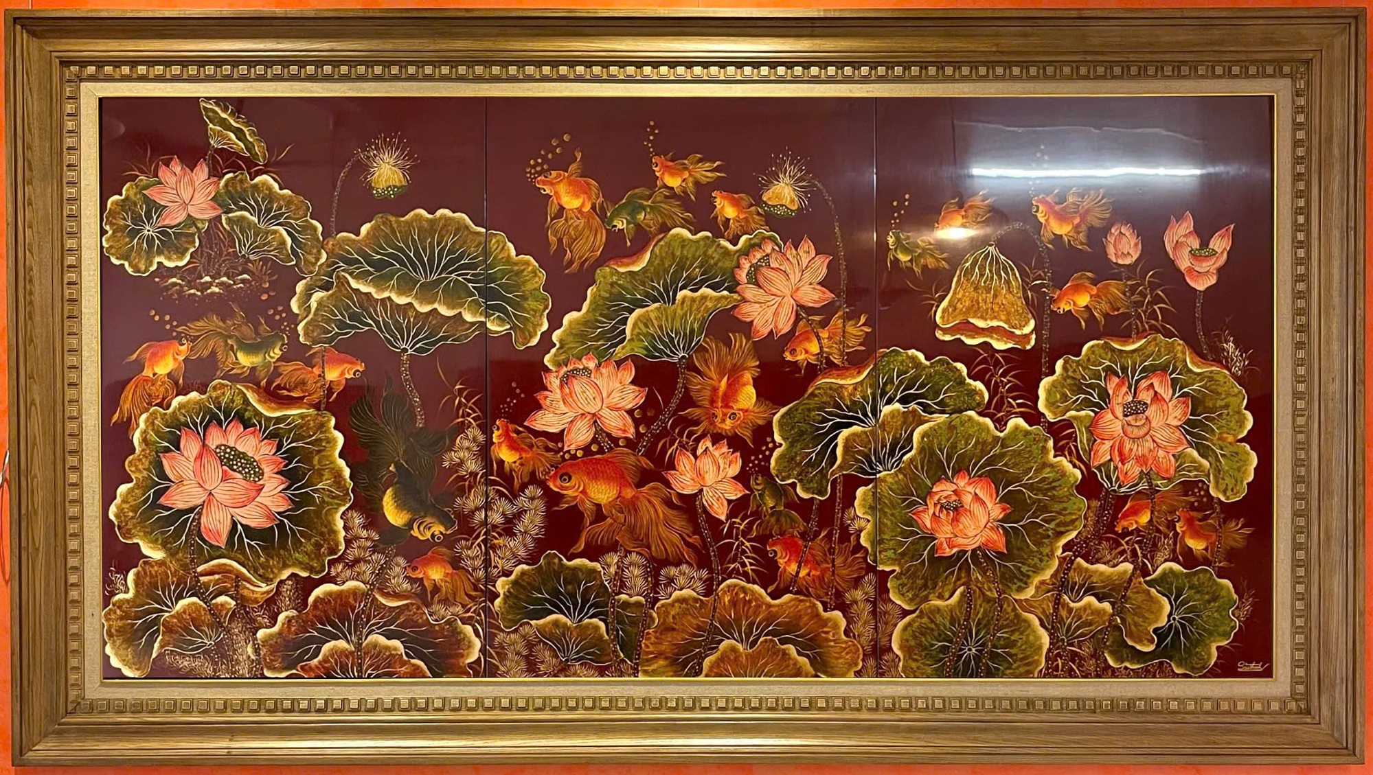 Ngư liên cát tường — Fish gather among lotus flowers and broad leaves in an expansive horizontal composition. The wide format gives the aquatic scene room to unfold.
