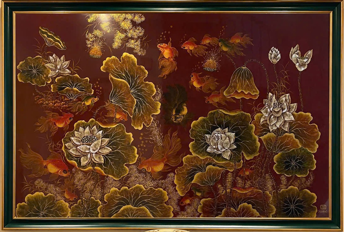 Ngư liên phú quý — Lotus flowers, foliage and fish fill a warm red-ground composition, combining rounded leaves with the flowing movement of fins and stems.
