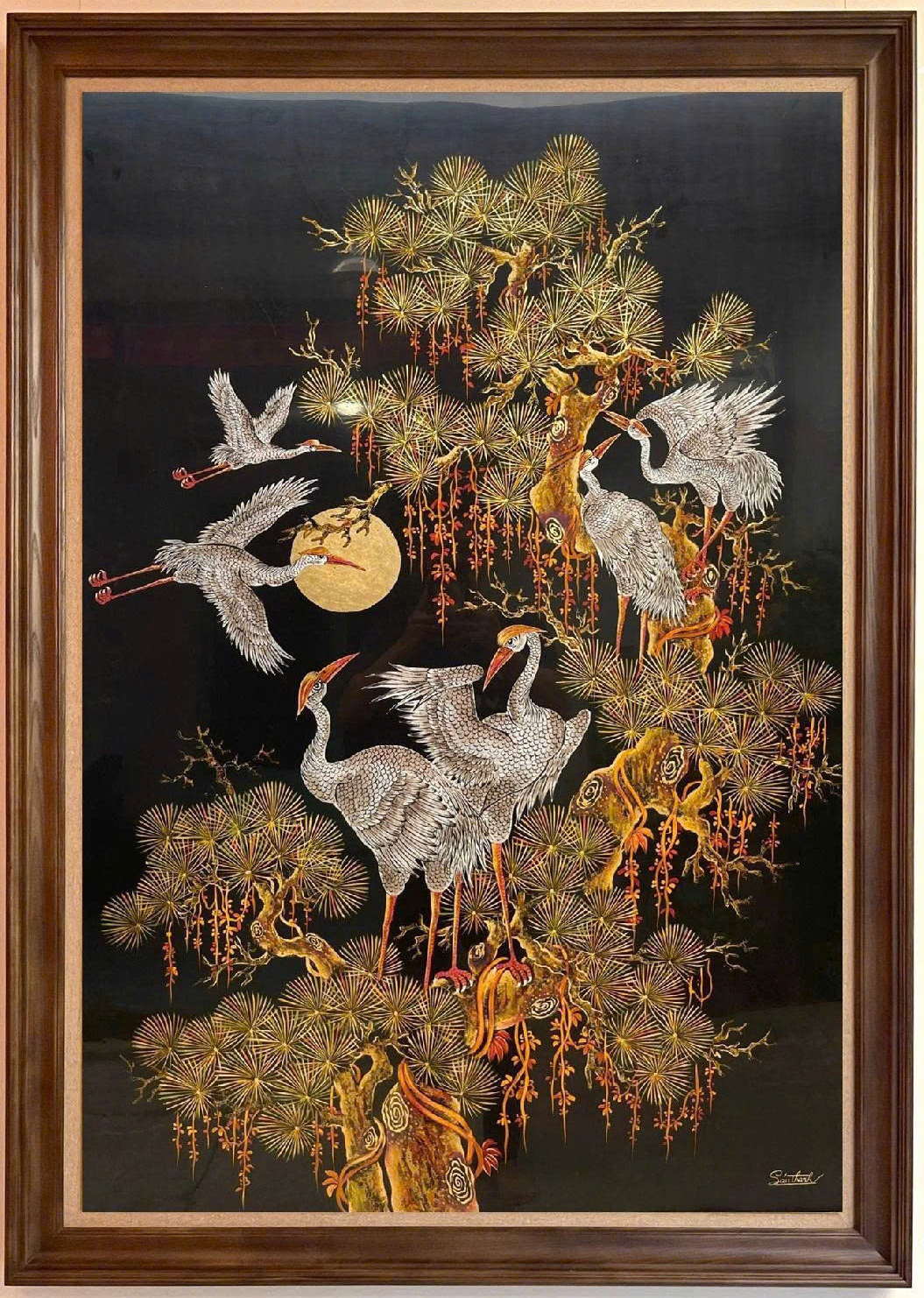 Tùng hạc diên niên — Pine branches and white cranes rise against a dark ground. This vertical composition balances pale birds with delicate golden-toned foliage.